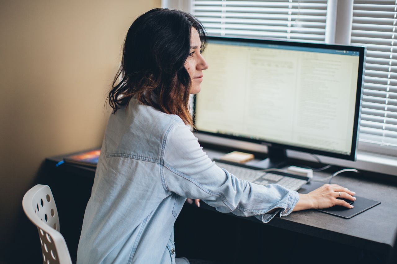 Employee organising business documents with metadata