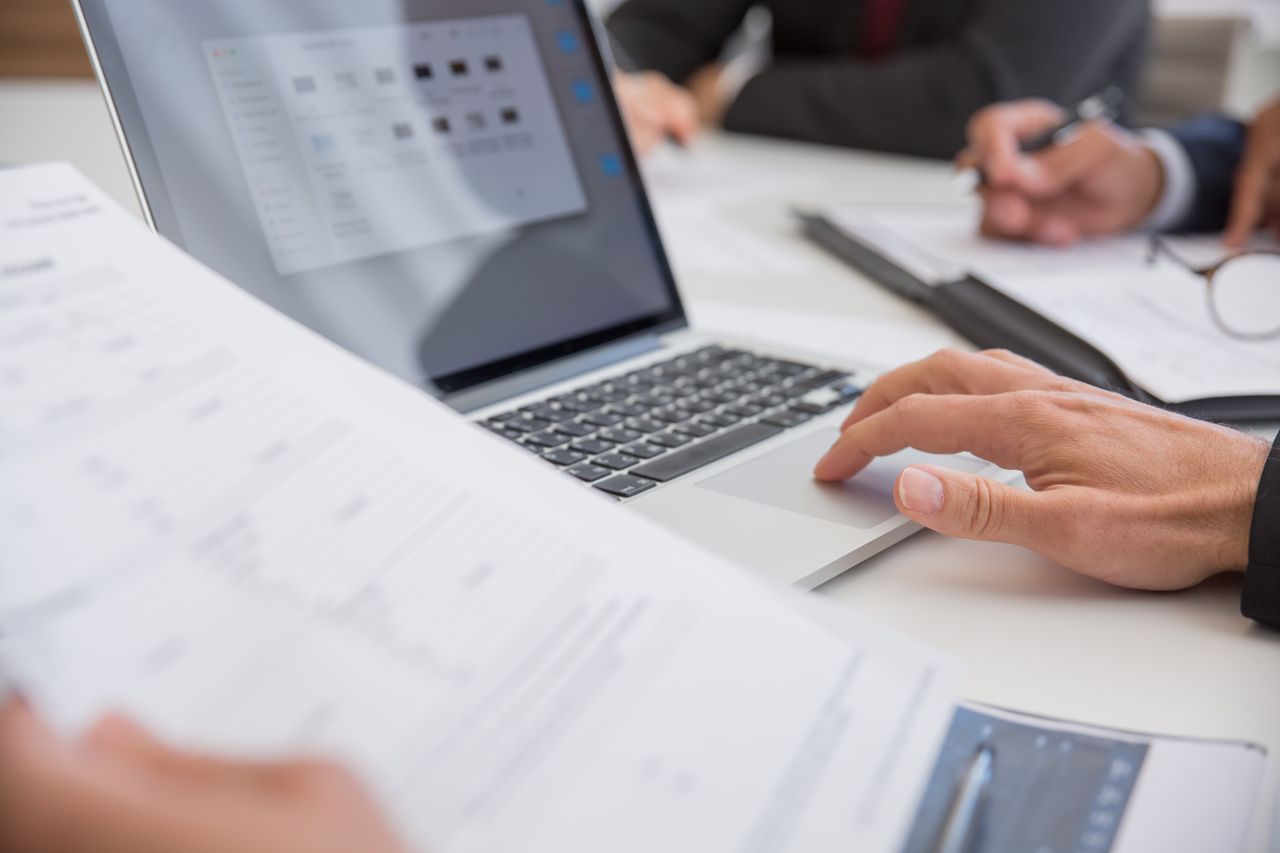 Business professional organising digital documents in a file management system